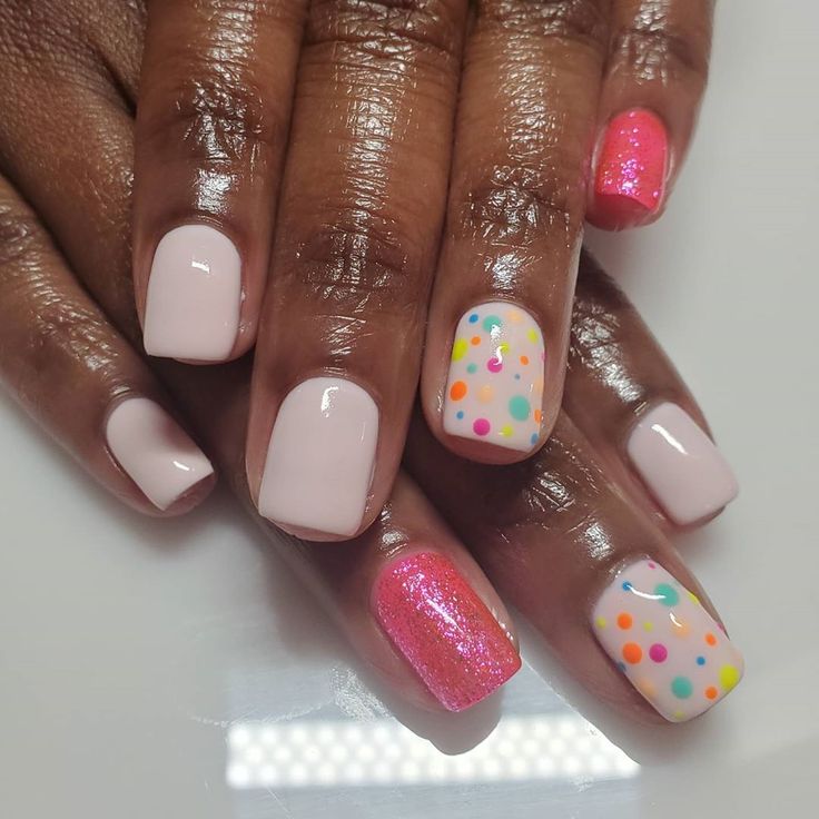 Playful Pastel and Sparkly Nail Design: A Cheerful Yet Sophisticated Look for Any Occasion.