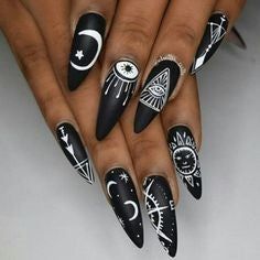 Edgy Black Stiletto Nails with Intricate White Celestial Designs