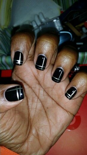 Sleek Black Nail Design with Sophisticated Metallic Stripes