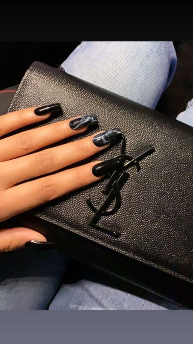 Chic Stiletto Nail Design: Glossy Black and Marble Elegance for Fashionable Occasions.