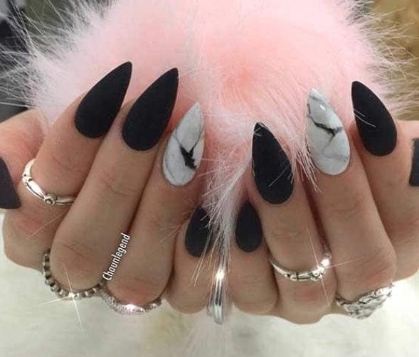 Elegant Stiletto Nail Design: Matte Black and Marble Accents for a Modern, Edgy Look.