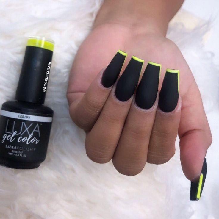 Striking Matte Black Nails with Vibrant Neon Yellow Tips for a Modern, Sophisticated Statement Look.