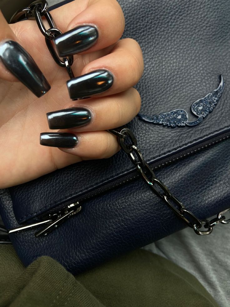 Elegant Dark Glossy Nail Design with Stylish Handbag for a Sophisticated Look