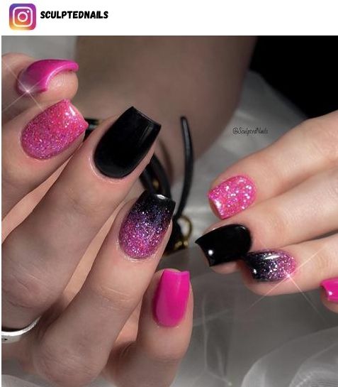 Bold Pink and Black Nail Design with Glitter and Gradient Effects.