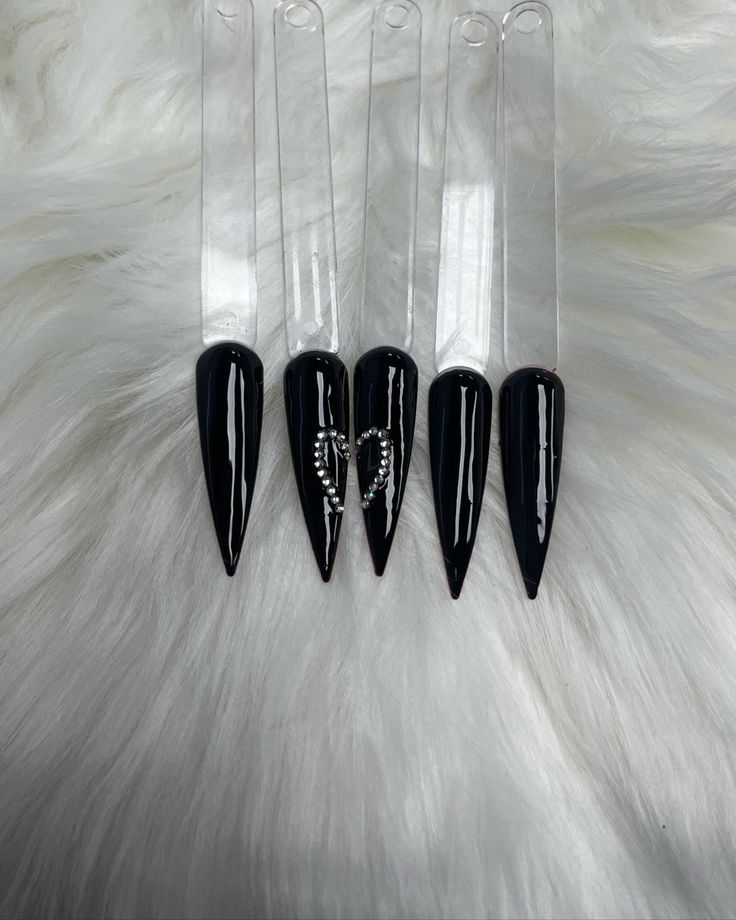 Bold and Elegant: Sleek Black Stiletto Nails Make a Striking Statement.