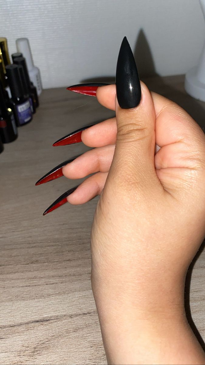 Dramatic Claw-Shaped Nails: Striking Black and Red Design for Bold Elegance.