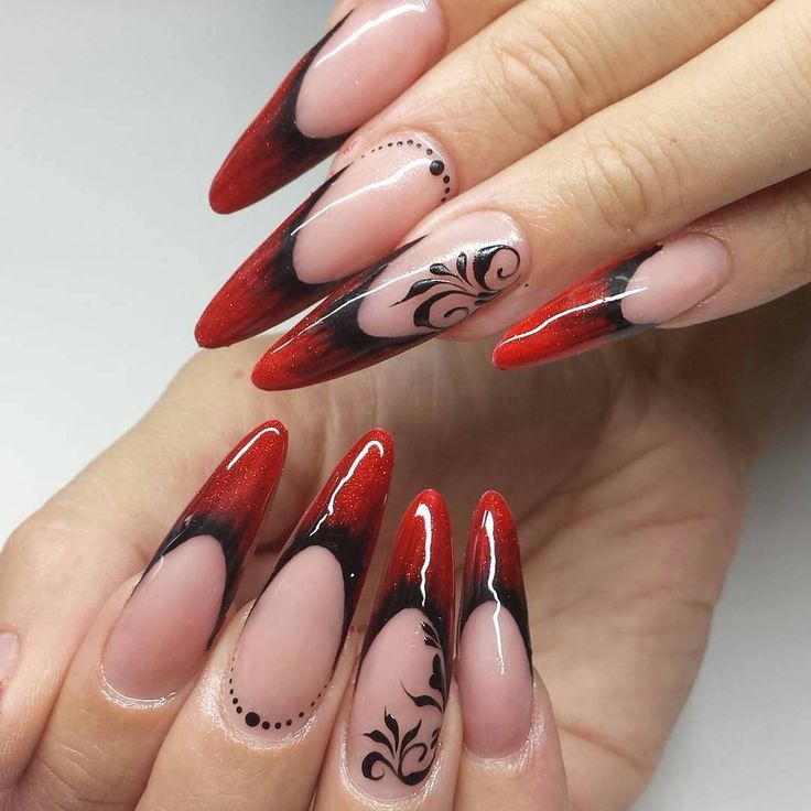 Stunning Stiletto Nail Design with Gradient Red-to-Black, Floral Patterns, and Glitter Finish.