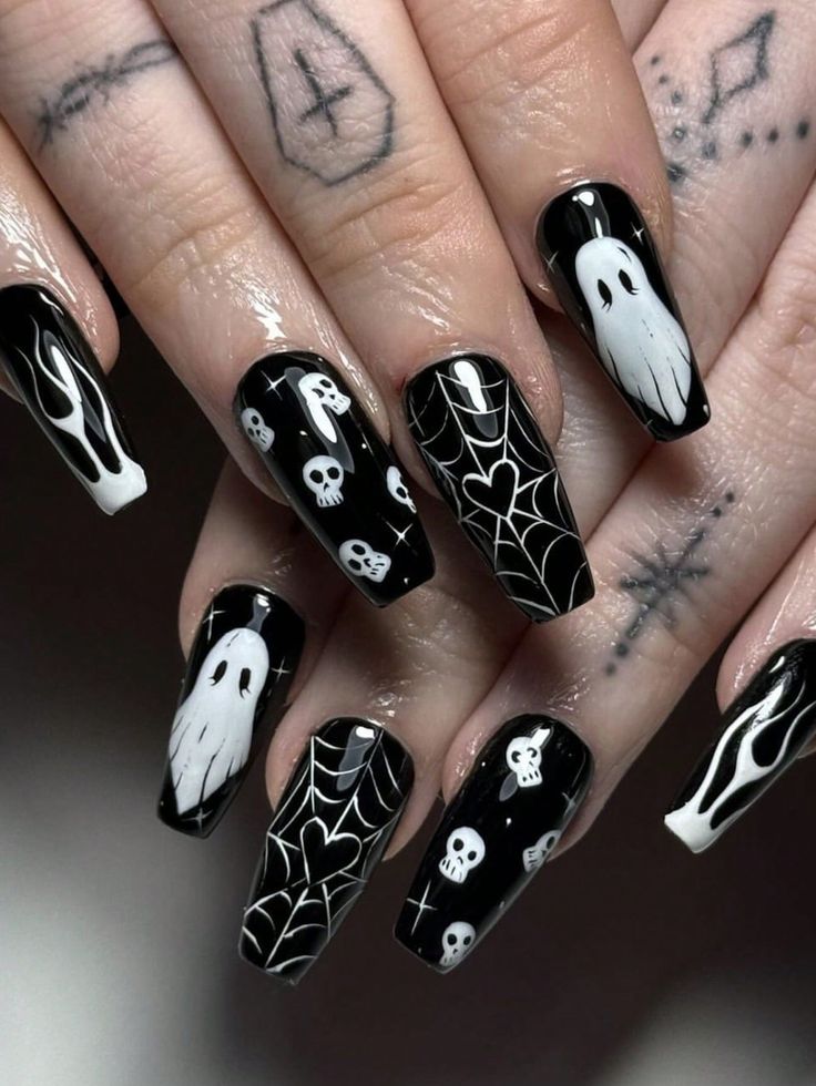 Gothic-Inspired Halloween Nail Art With Striking Black Background and Spooky White Designs.