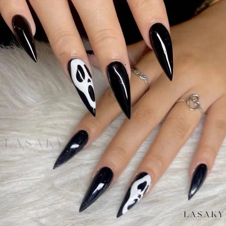 Bold Stiletto Nails: Striking Black Base with Edgy White Horror Motifs