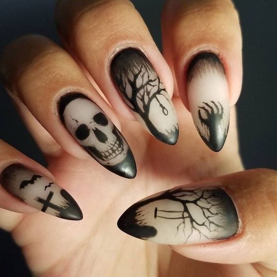 Gothic-Inspired Edgy Nail Art: Intricate Black Designs on Matte Finish with Skull and Tree Motifs.