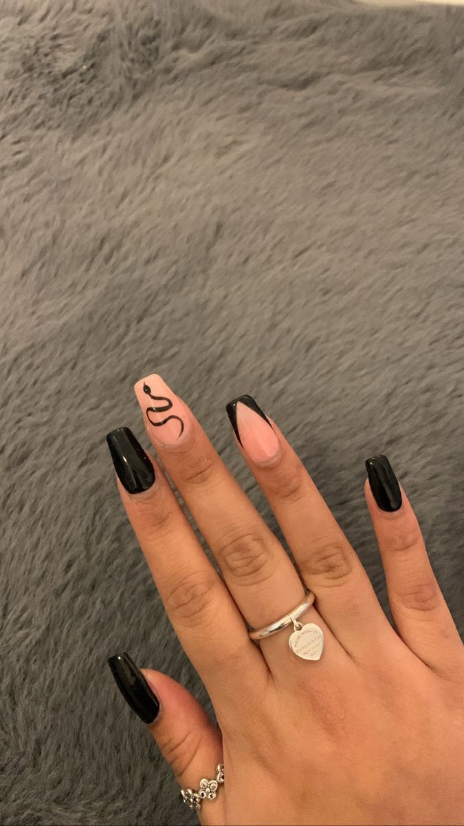 Chic Nail Design: Matte Black and Soft Pink with Abstract Accent.