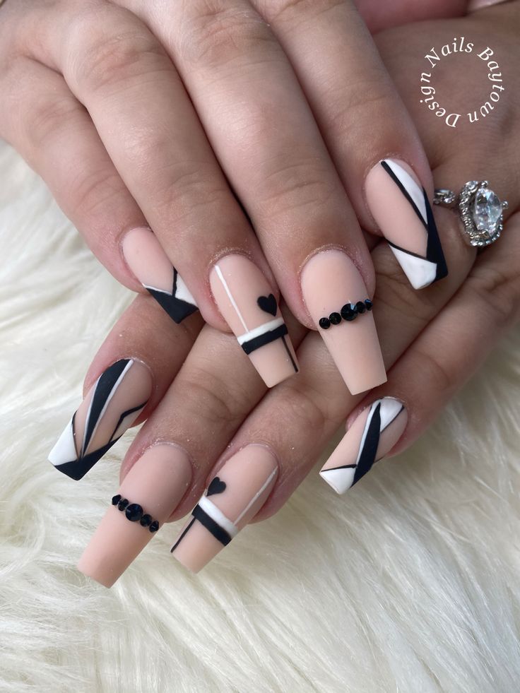 Chic Nail Design with Geometric Patterns and Matte Finish in Bold and Neutral Colors.