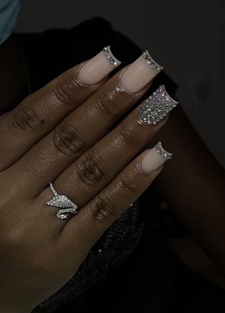 Elegant Nail Design with Nude Base and Rhinestone-Embellished Tips for a Chic Aesthetic.