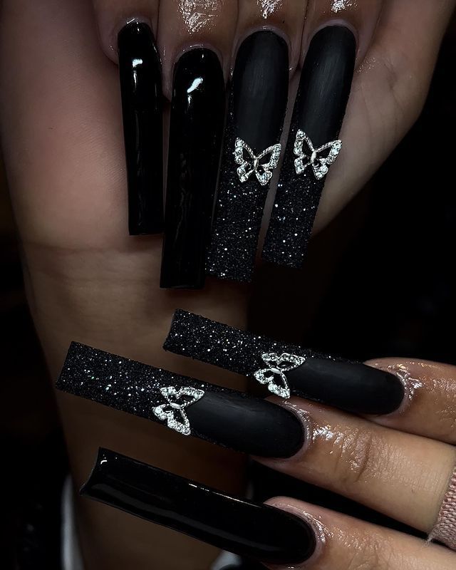 Chic Long Black Glitter Nails with Rhinestone Butterfly Accents.