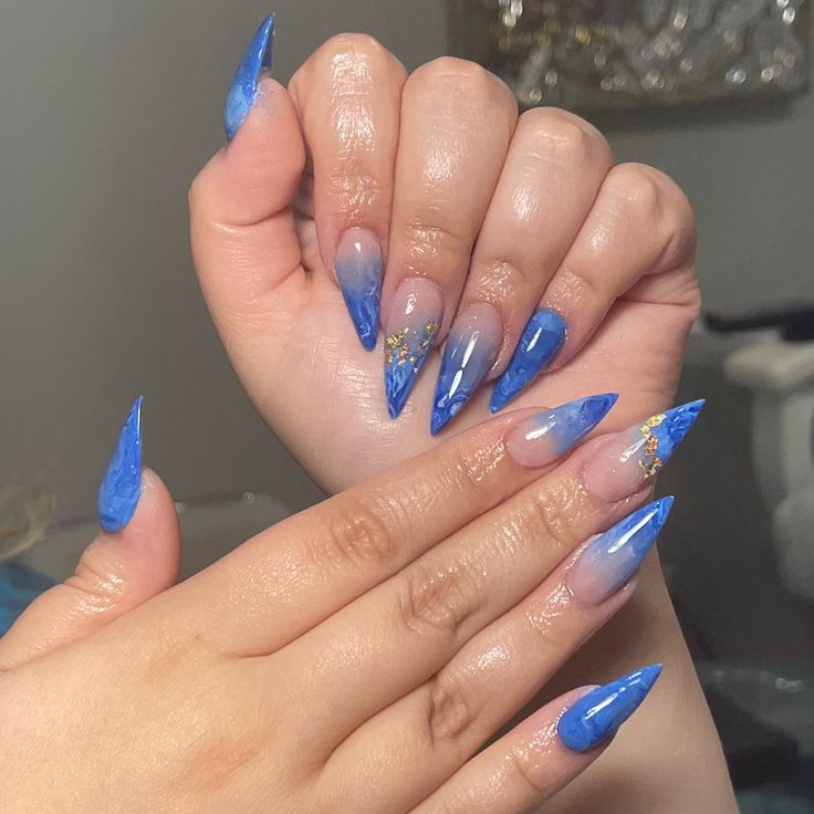 Elegant Blue Ombre Nails with Glossy Finish and Gold Embellishments