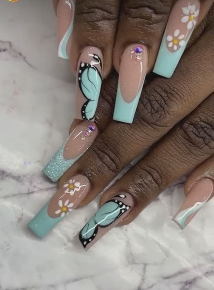 Playful Pastel Nail Design with Floral Patterns and Sparkling Embellishments