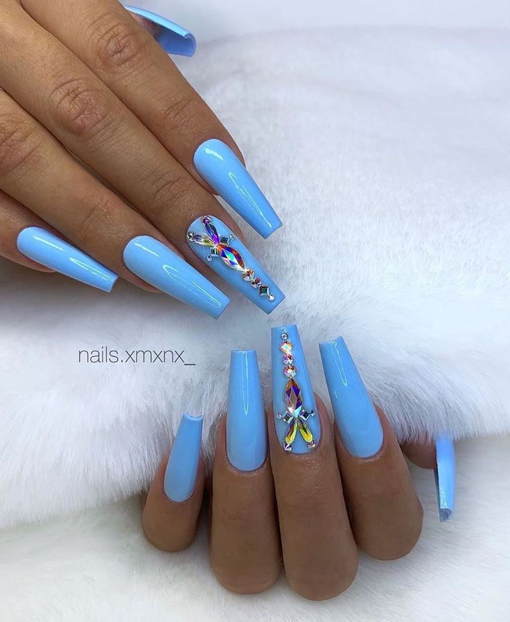 Stunning Blue Stiletto Nails with Glamorous Gem Accents for a Bold Statement.