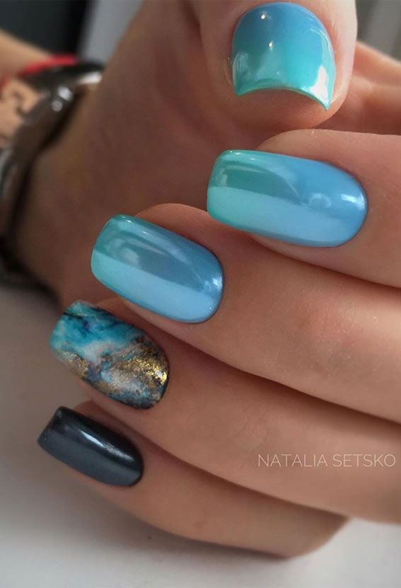 Tranquil Elegant Blue Nail Design with Gradient and Marble Accents.