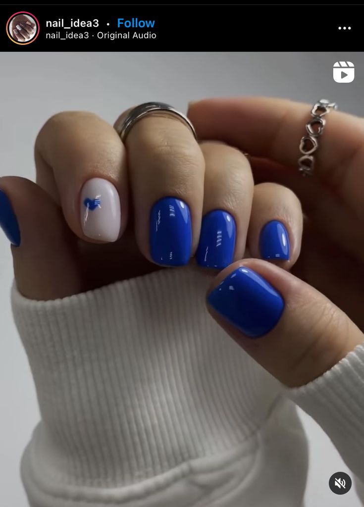 Chic Vibrant Blue Nails with Playful White Accent for a Modern Look