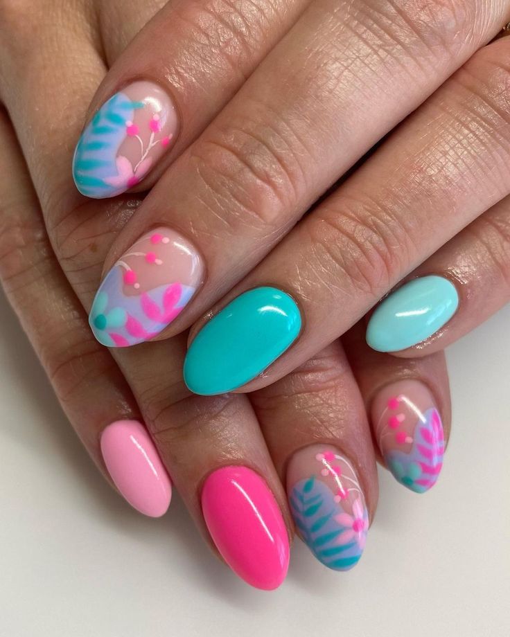 Playful Pastel Nail Art: Whimsical Designs in Turquoise, Pink, and Blue.