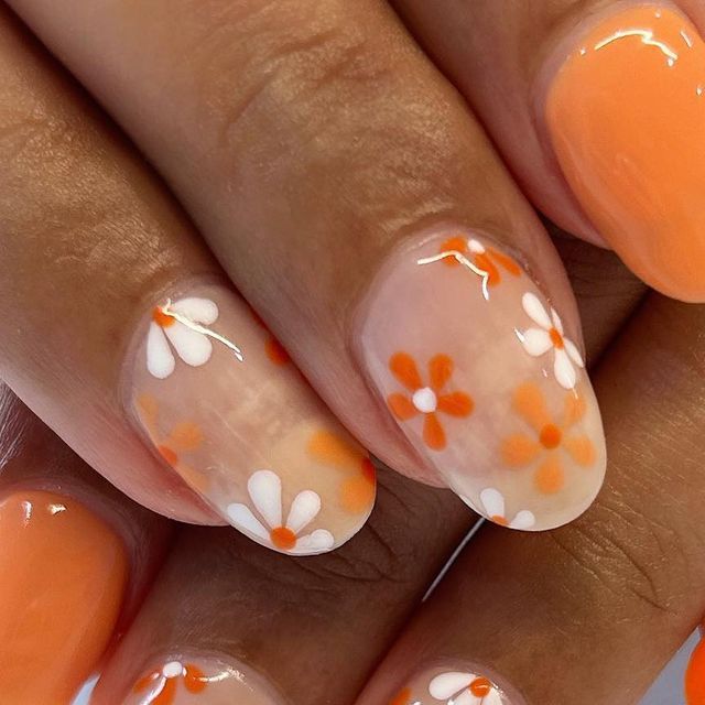 Elegant Spring Floral Nail Design with Peach Base and Charming Flower Patterns.