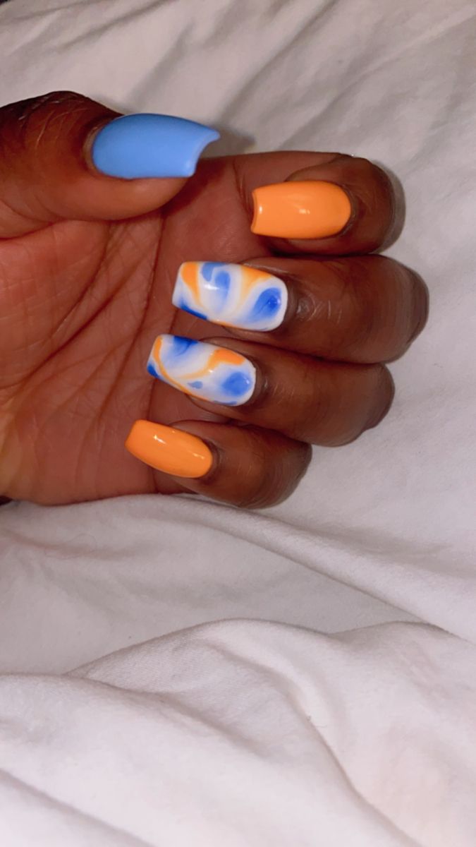 Vibrant Blue and Orange Nail Design: A Playful and Artistic Manicure.