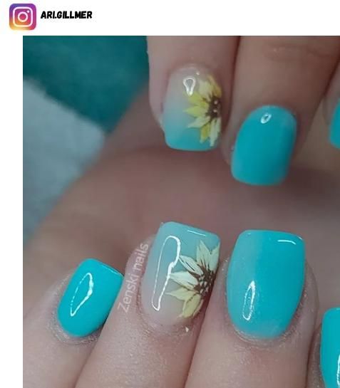 Vibrant Turquoise Nail Design with Nature-Inspired Sunflower Accents and Glossy Finish.