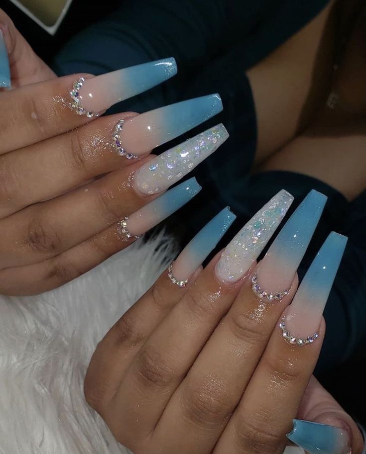 Elegant Ombre Nail Design with Soft Blue Shades, Clear Glitter, and Sparkling Rhinestones.