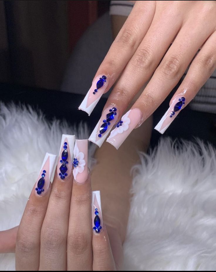 Sophisticated Nail Design: Long Square Tips with Floral Patterns and Blue Gemstones