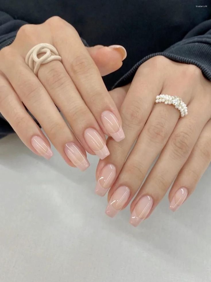 Elegant French Manicure: Nude Base with Soft Pink Tips and Chic Ring Accents