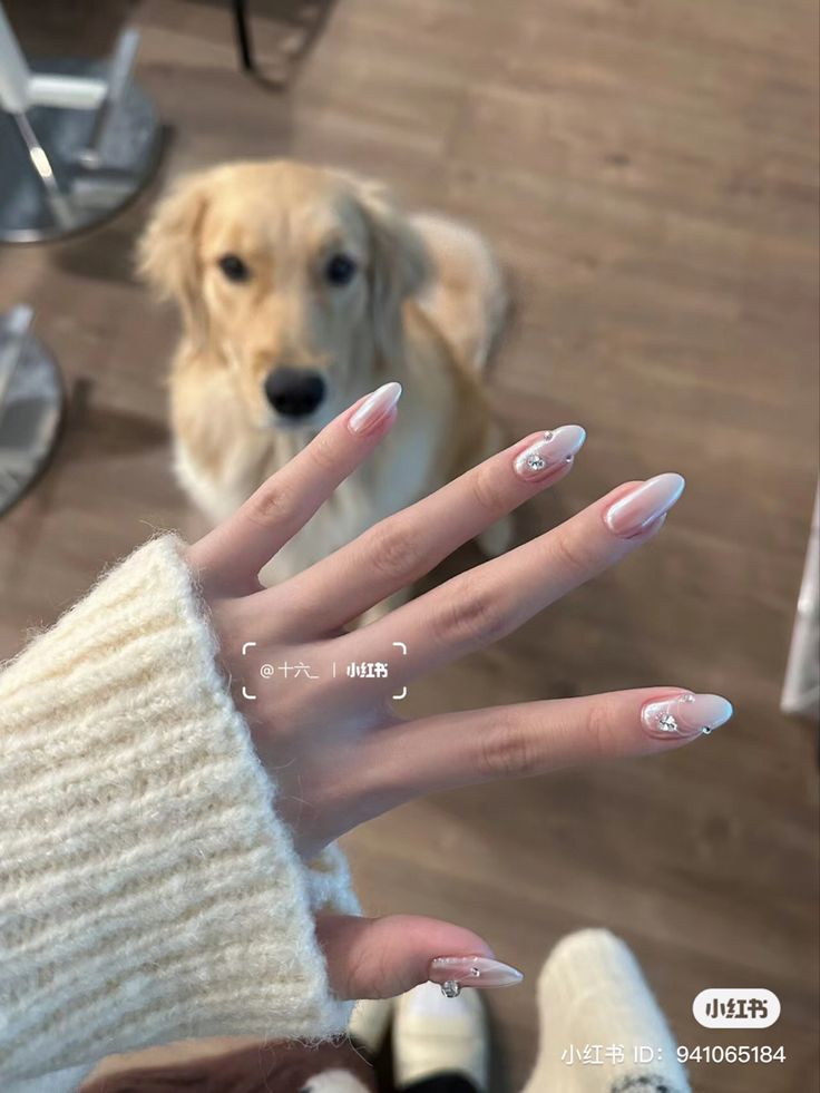 Chic Soft Pink Ombre Almond Nails with Crystal Accents and Clear Tips.