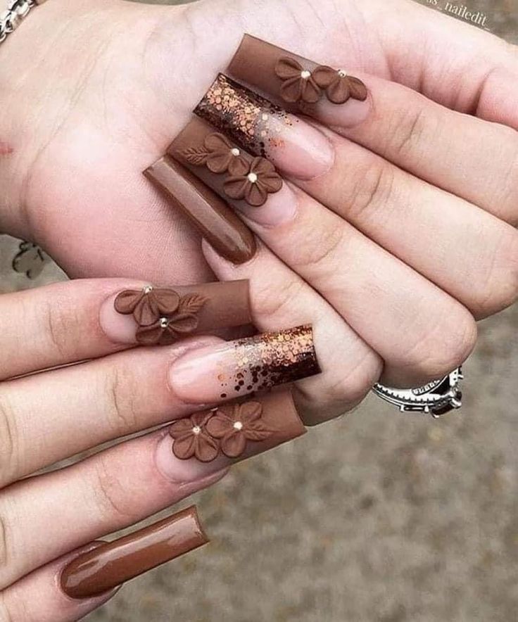 Sophisticated Chocolate Brown Nail Design with Floral Accents and Gold Glitter