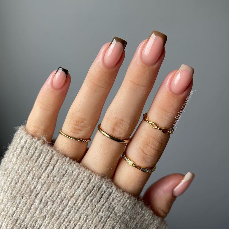 Sophisticated Nude and Dark Tip French Manicure with Gold Accents.