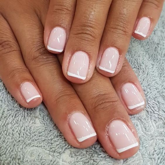 Elegant Soft Pink and White French Manicure: A Classic and Versatile Aesthetic.