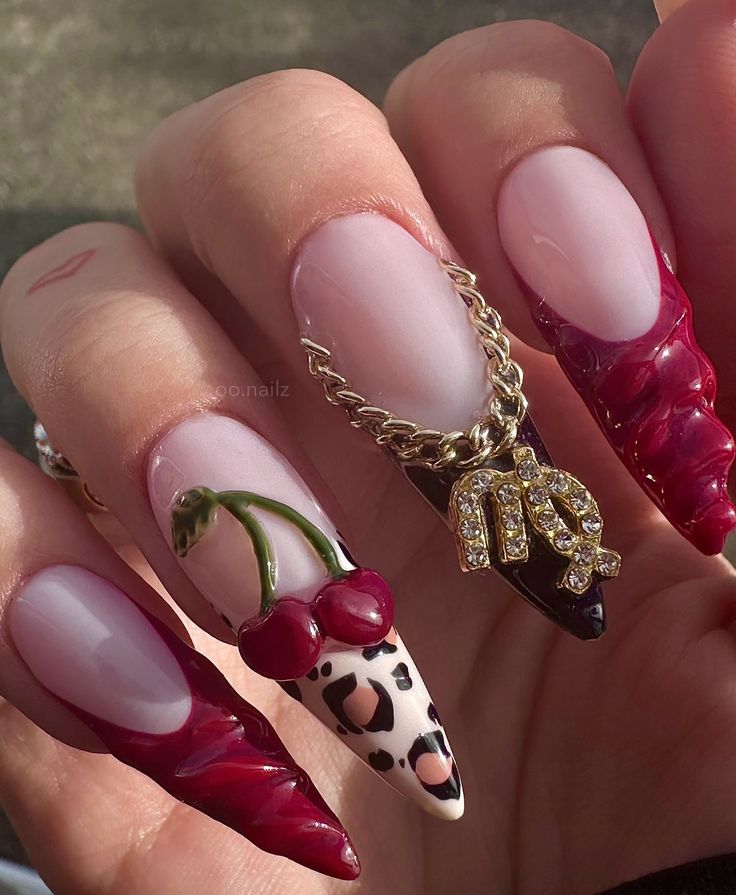 Vibrant Stiletto Nail Art with Cherry Accents, Leopard Print, and Glamorous Gold Chains