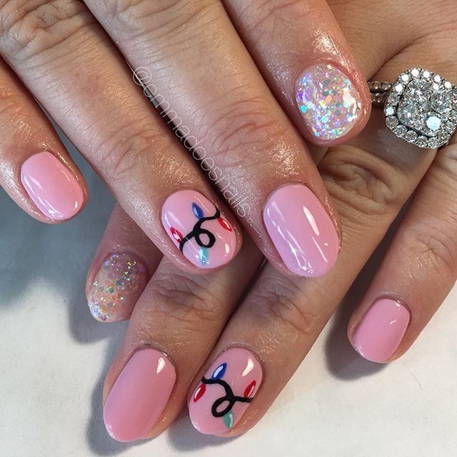 Charming Pink Nail Design: Playful Elegance with Whimsical Patterns and Sparkling Glitter.