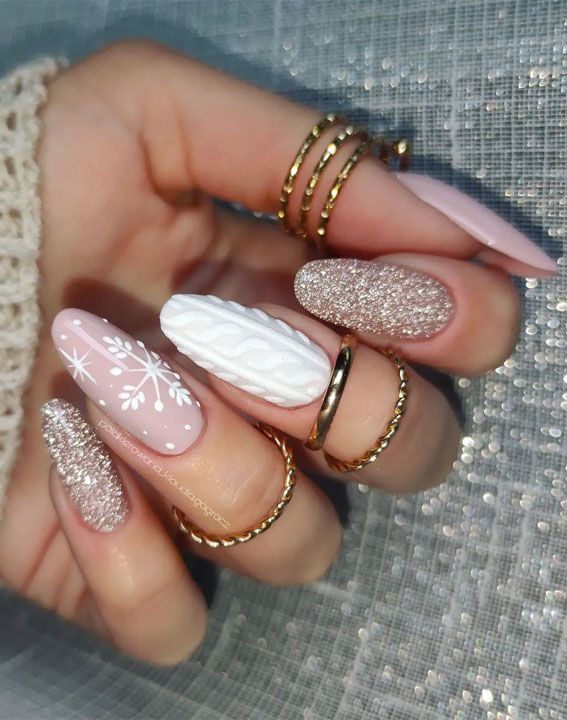 Sophisticated Winter Nail Design: Soft Pink, Glitter, and Textured Snowflake Accents