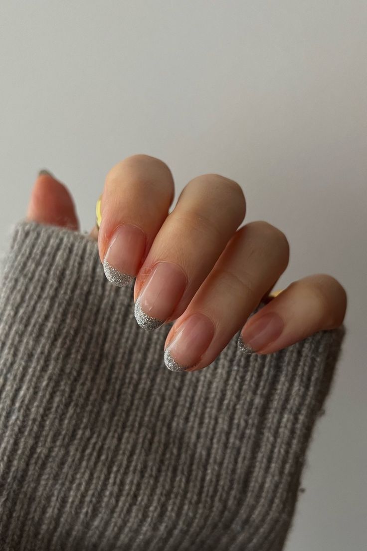 Nude Base with Delicate Silver Glitter French Tip: A Perfect Blend of Simplicity and Sophistication.