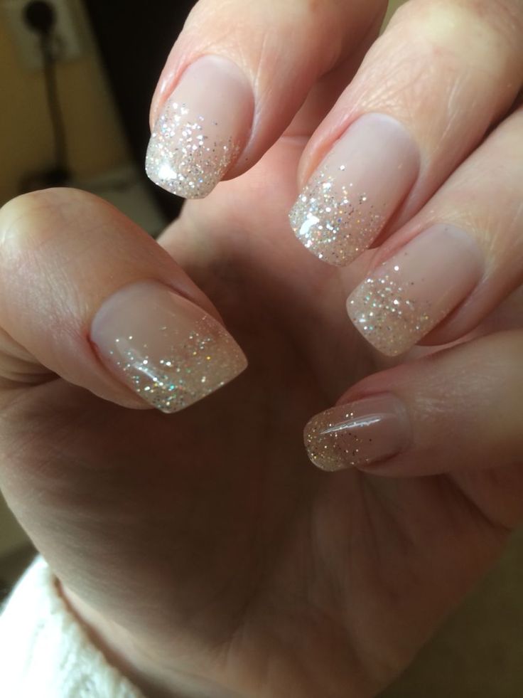 Elegant Soft Nude Nails with Sparkling Glitter Tips for Chic Occasions.