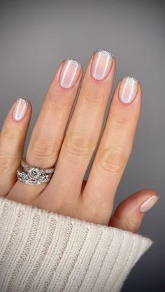 Sophisticated Minimalist Nail Design: Translucent Nude Base with Delicate Silver French Tips.