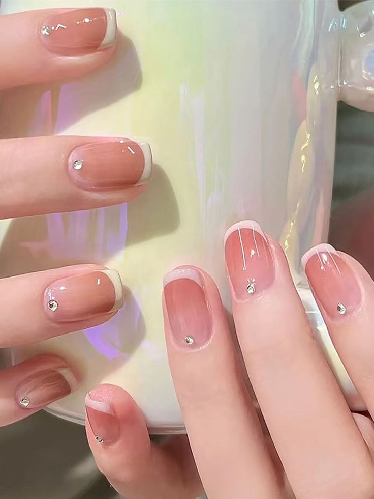 Elegant Nude French Tip Manicure with Rhinestones for a Polished Look.