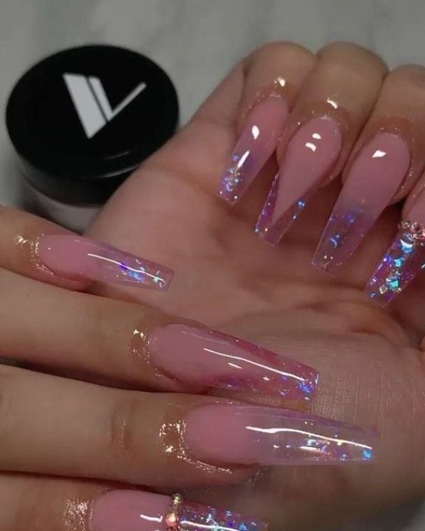 Elegant Long Pink Acrylic Nails with Iridescent Accents for a Glamorous Look.