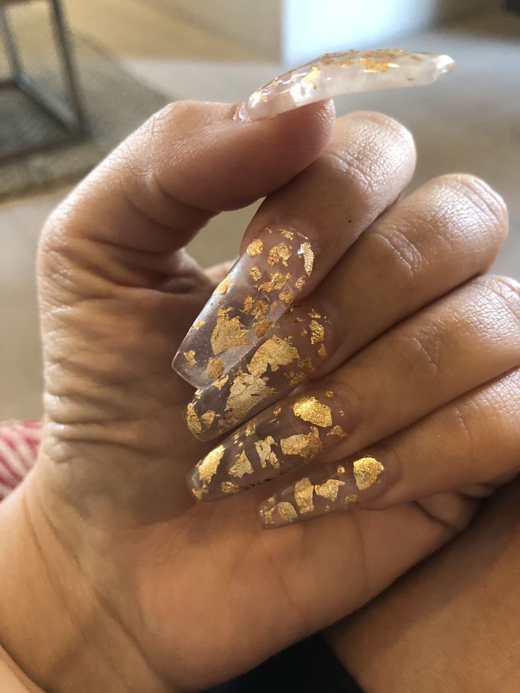 Chic Coffin-Shaped Nails with Clear Base and Gold Foil Accents for a Modern Glam Look.