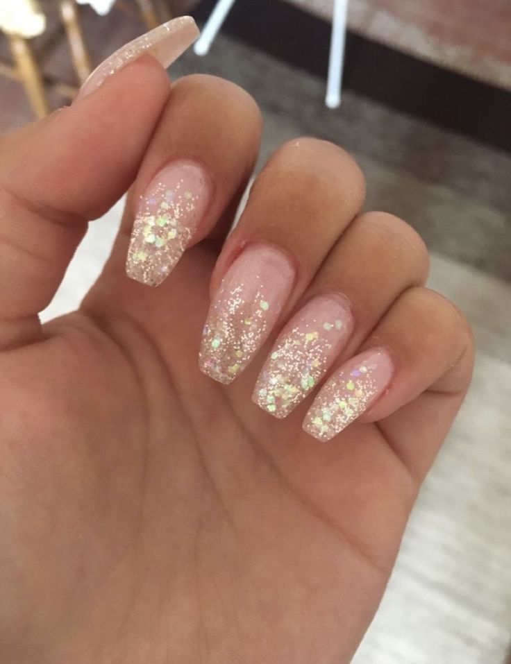 Elegant Glittery Ombre Nails: Soft Pink Base with Sparkling Gold Flecks for a Glamorous Touch.