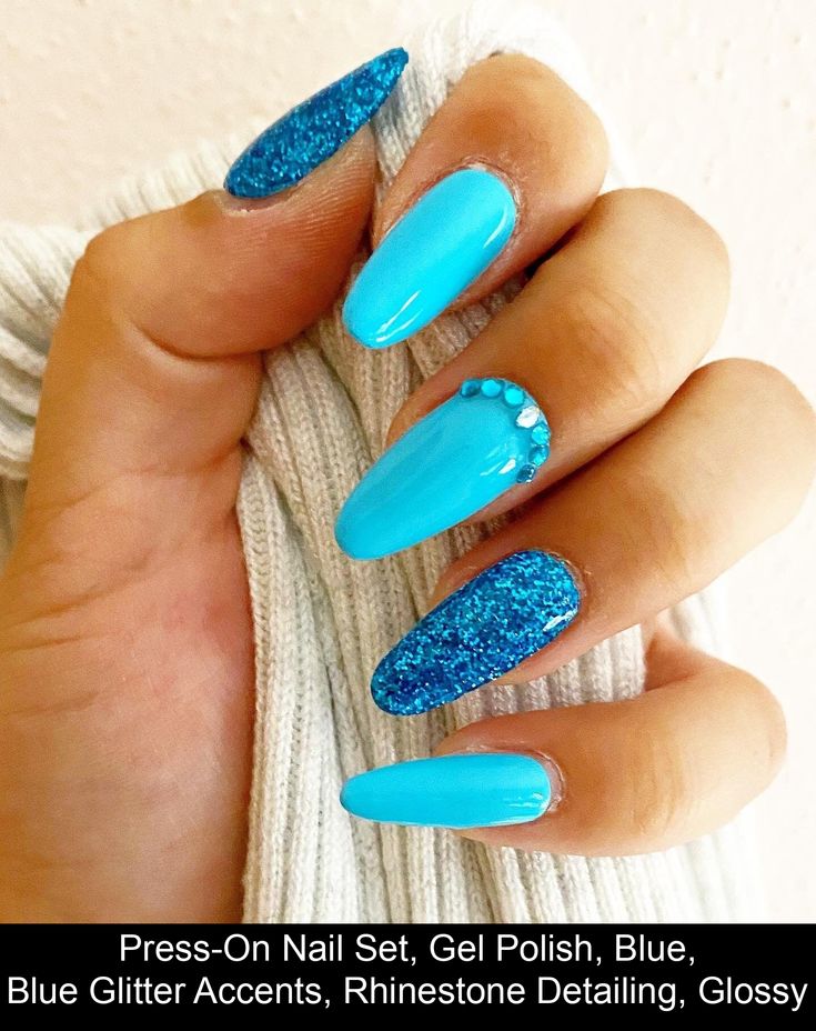 Bold Blue Glossy Nail Design with Glitter Accents and Rhinestone Detail.