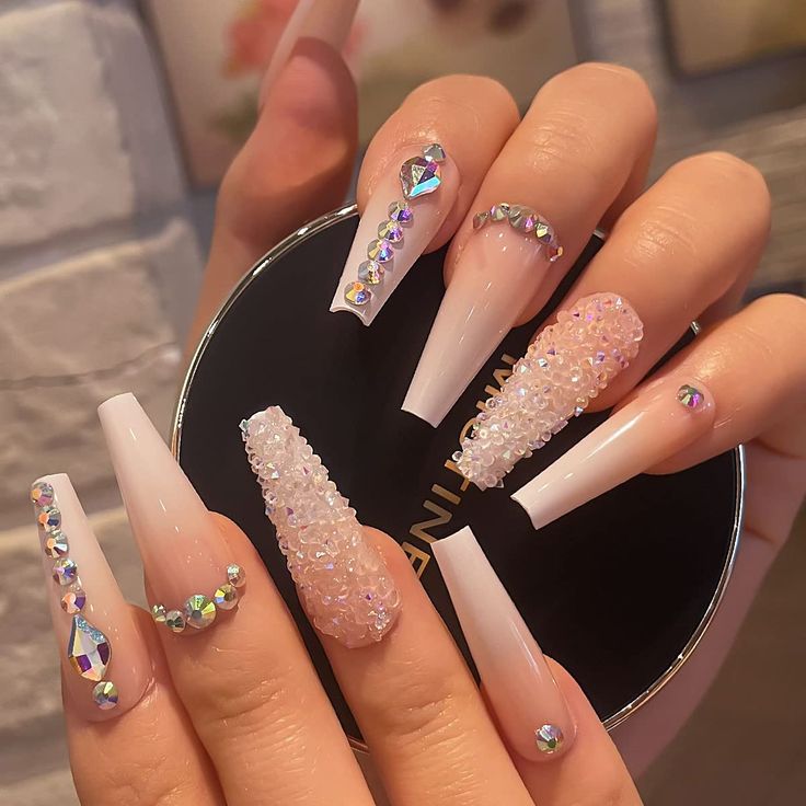 Elegant Glamorous Nail Design with Long Square Tips and Intricate Rhinestone Embellishments.