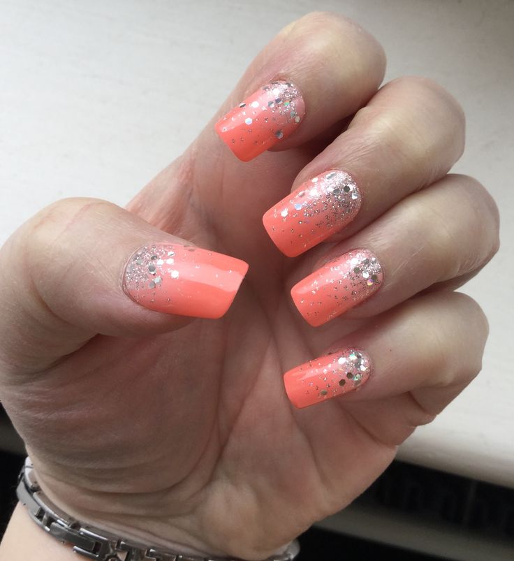 Vibrant Coral Nail Design with Shimmering Gradient and Glitter Accents for a Chic Look.