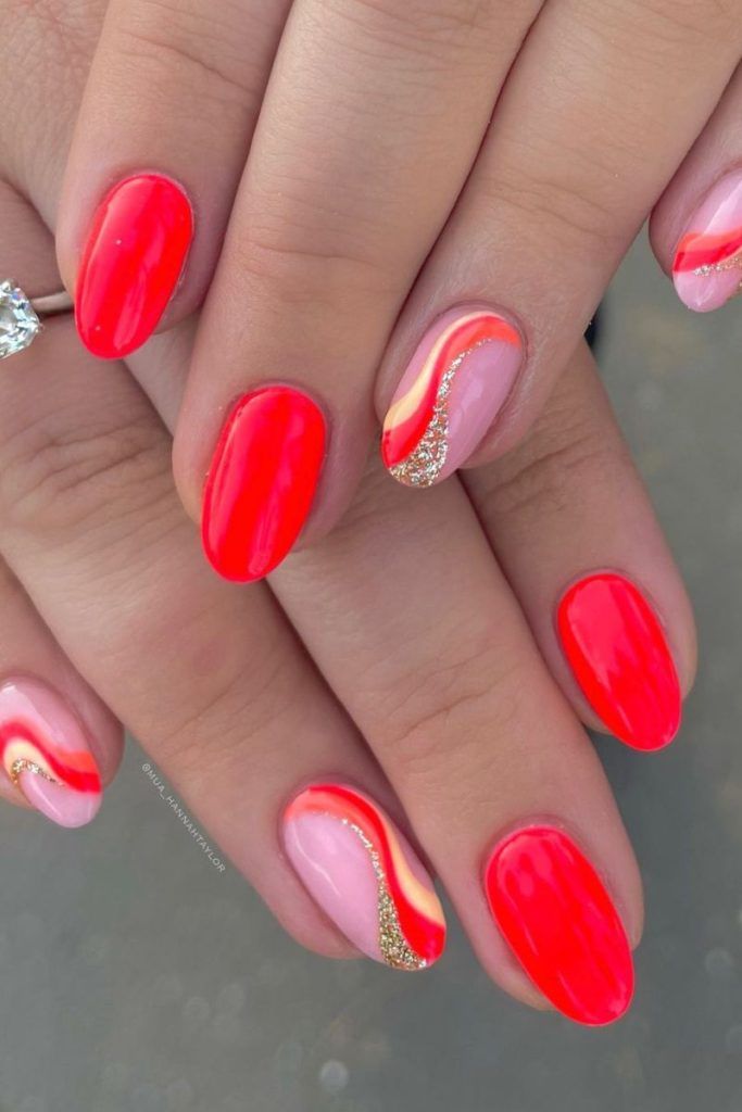 Striking Nail Design: Glossy Red and Elegant Pink with Wavy Lines and Sparkles.