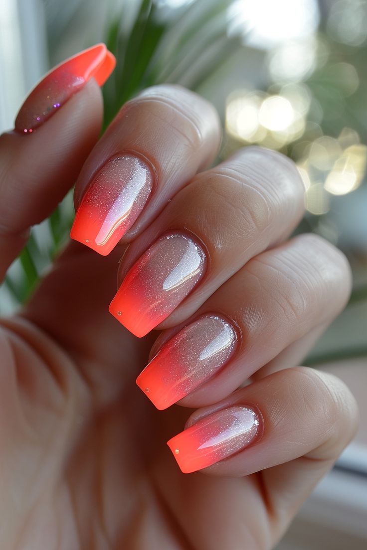 Elegant Gradient Nail Design with Vibrant Orange Tips and Shimmering Base