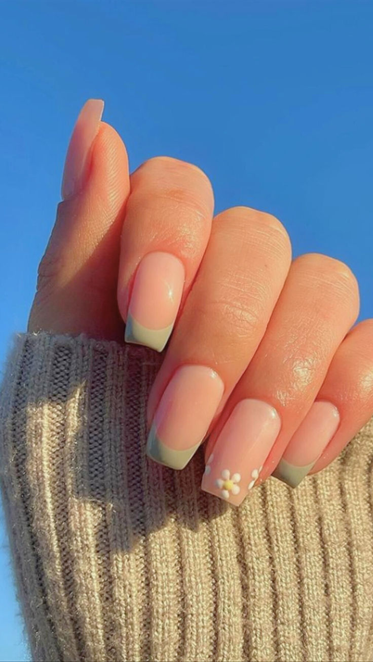 Charming Pastel Nail Design: Soft Pink Base with Mint Green Tips and Floral Accent.